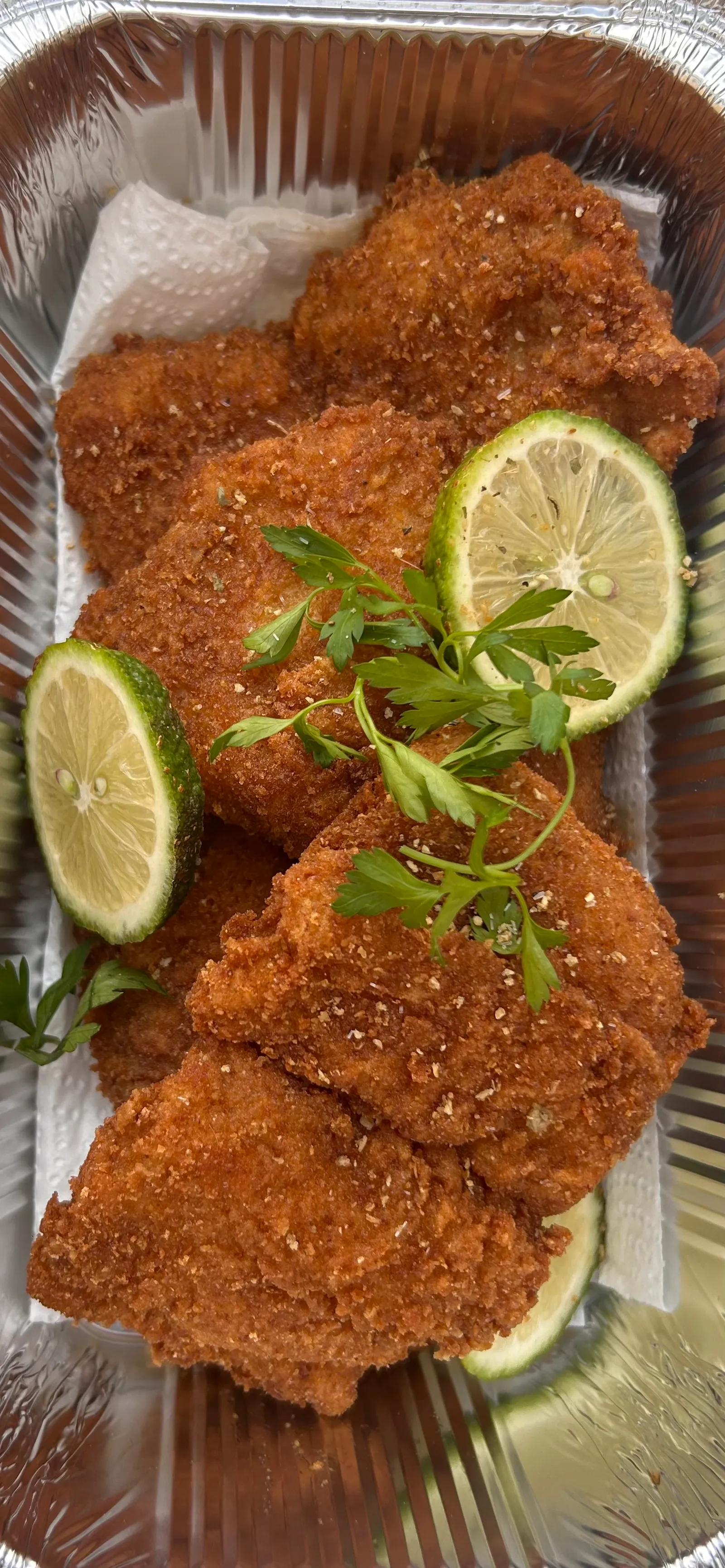 Golden breaded portions garnished with citrus slices and herbs